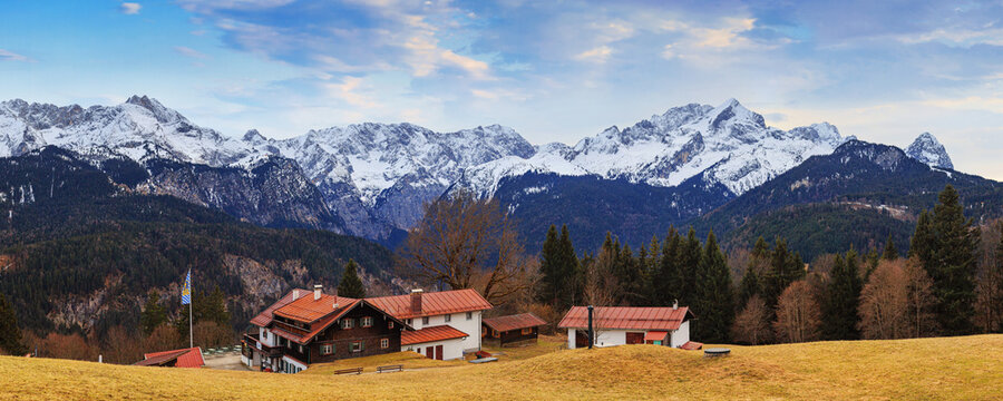 Rural landscape, panorama, banner - view of the countryside near in the alpine ski town of Garmisch-Partenkirchen against the background of the Alps, in Upper Bavaria, Germany