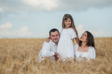The concept of a friendly family.Cool photo session in a field