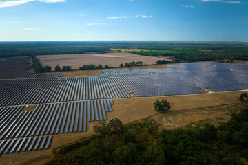 Aerial view of large sustainable electrical power plant with rows of solar photovoltaic panels for...