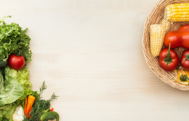 The diet nutrition concept is based on healthy clean eating lifestyles. Fresh vegetables ingredients for salad are displayed on white table background in top view. A round frame is isolated with