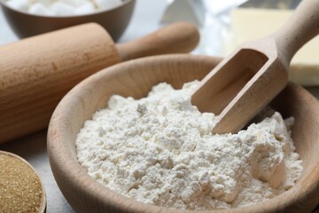 Ingredients for dough and rolling pin on table, closeup