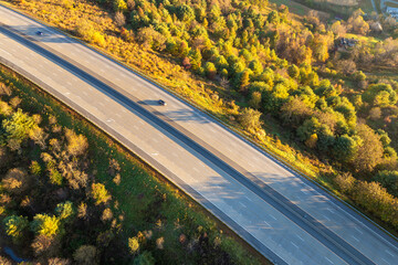 Wide multilane highway road in USA with fast driving cars. Above view of American transportation...