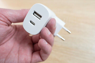 White USB charger with both USB-A and USB-C ports, perfect for fast charging multiple devices,...