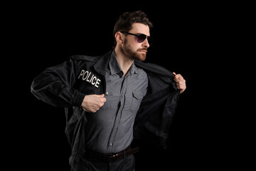 Male police officer on black background