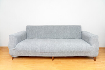 Modern Minimalist Grey Sofa with Stretch Slipcover in Bright Living Room. Stylish and Functional Couch. Perfect for Home interior Design. ideal for home, apartment, and furniture design.
