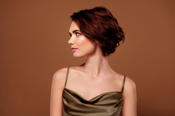 Naklejka premium Photo of lovely young lady look empty space promo dressed stylish khaki garment isolated on brown color background