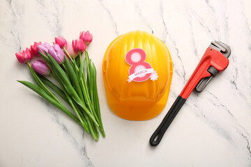 Tulip flowers with plumber's pipe wrench, helmet and paper figure 8 on grunge white background....