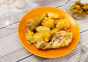 Just cooked braised chicken with potatoes served on table.
