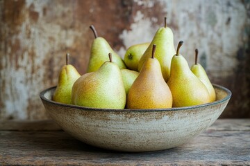 Rustic bowl of fresh yellow-green pears on wooden surface