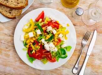 Delicious light vegetable salad of tomatoes, canned corn, pepper and Feta cheese