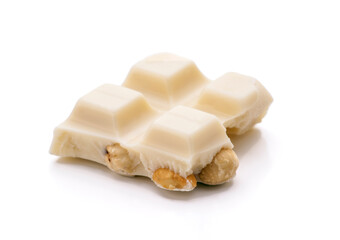 White chocolate bar with hazelnuts on white background