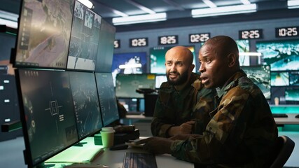 Army unit working in governmental facility next to coworker, doing brainstorming, operating...