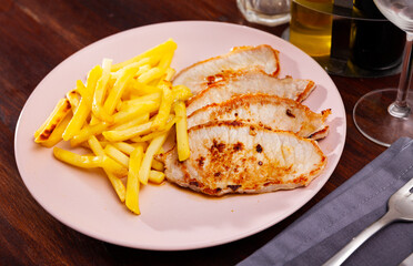 Appetizing grilled pork loin chops with french fries