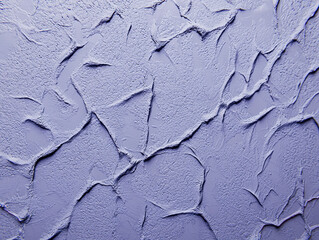 Close-up textured background of purple paint with a cracked and uneven surface.