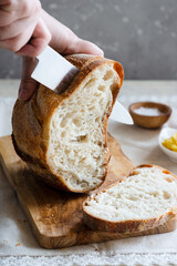Woman hands cutting fresh bread
