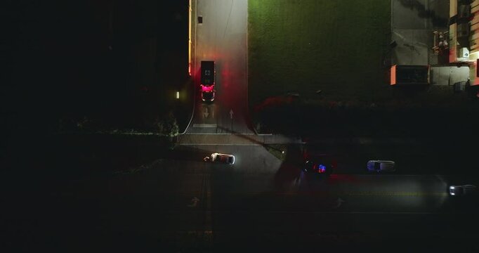 Traffic accident on American street in Florida at night. First responders helping victims of car crash on road in USA. Aerial view of emergency services responding to accident site.