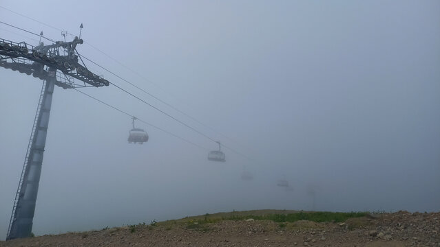 Cable car in the fog. - Powered by Adobe