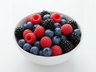 A white bowl filled with a colorful assortment of raspberries, blackberries, and blueberries.