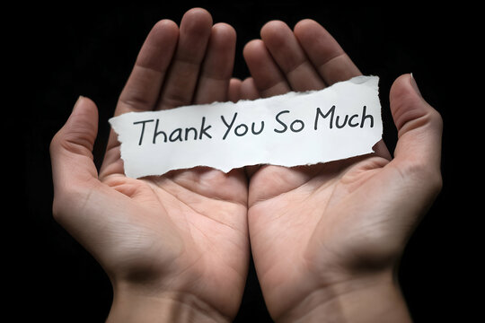 Open hands holding torn thank you so much message, showing deep appreciation, gratitude, kindness, and sincere emotion