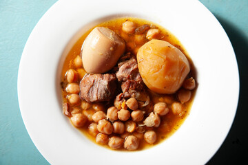 Chickpea stew with meat, potato, and egg comforting winter meal