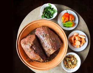 Seasoning beef with cilantro, habanero peppers, sweet potatoes and sofrito for marinating