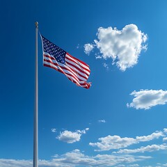 American flag waving in clear blue sky