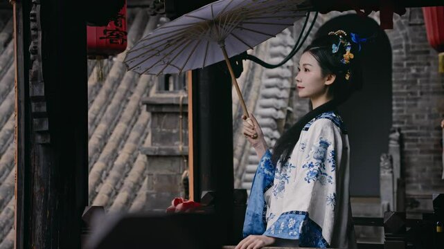 Girl dressed in Jin Merchant costume enjoys the heritage at Ma Family Residence in Pingyao Ancient City