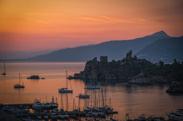 Panoramic sunrise view of sea port of Cefalu, Metropolitan City of Palermo, coastal town in northern Sicily, Italy. August 2024.