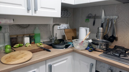 A mess in the kitchen, dirty dishes on the table, scattered things, unsanitary conditions. kitchen...