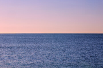 Obraz premium Sunrise Seascape, ocean, horizon, sky, and calm sea waves, minimalistic coastal landscape