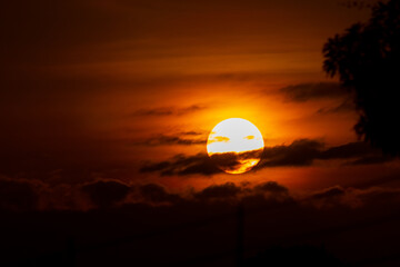 Sunset behind the clouds in the sky, beautiful and dramatic.