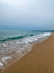 Serene beach landscape with gentle waves and distant skyline