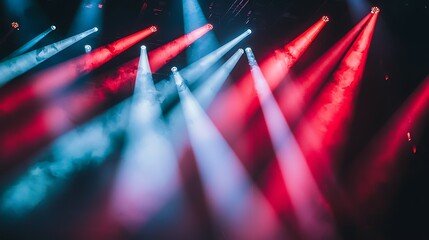 Red and blue stage lighting illuminates smoky concert