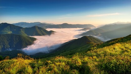 Fog and ocean of clouds in the mountain valley; highlands and low lying clouds in the mountainous valley with blue skies; beautiful landscapes; dramatic scenery