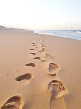 Footprints in the Glifada beach, Greece.