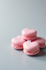Fototapeta premium A Delicate Arrangement of Pink Heart-Shaped Macarons on a Subtle Gray Surface