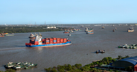 Cargo ship transporting containers on Saigon River from port to East Sea