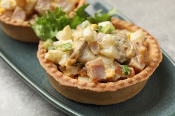 Tartlets with delicious filling on grey table, closeup