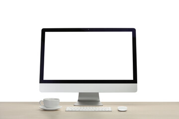 Fototapeta premium Computer monitor, keyboard, mouse and cup of drink on wooden desk against white background