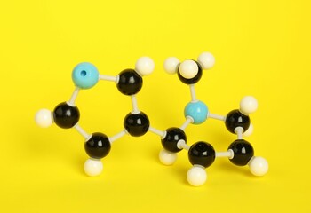 Chemical model of molecule on yellow background