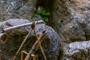 Bamboo Water Fountain - Souzu fountain. Japanese Shishi Odoshi Deer Scarer. Element of Japanese garden - shishi-odoshi. Traditional Japanese Bamboo Water Fountain