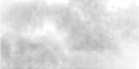 Halftone faded gradient texture. Grunge halftone grit background. White and black sand noise wallpaper.