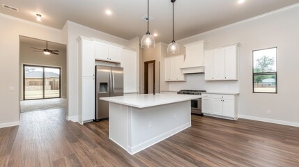 Modern kitchen interior featuring an island, stainless steel appliances, and natural light