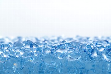 Clear blue gel beads reflecting light on a smooth surface during daytime. Generative AI