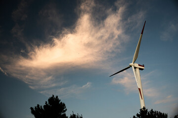 夕空にそびえる風力発電機