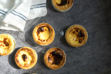 Naklejka premium Egg tart, traditional Portuguese dessert, pastel de nata. Pasteis de Belem is a Portuguese egg custard tart pastry.
