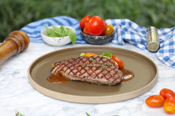 Grilled steak dish outdoor setting food photography natural light culinary delight