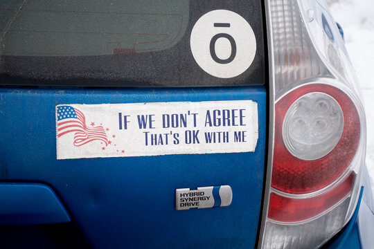 Bumper sticker on car honoring differing opinions being patriotic. "If we don't agree, That's OK with me'" St Paul Minnesota MN USA