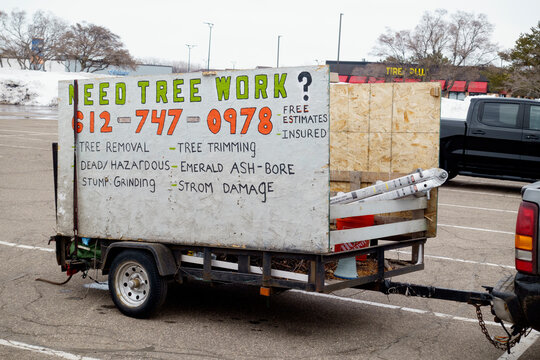 Enterprising company advertising tree work and a phone number on the side of their makeshift trailer. St Paul Minnesota MN USA