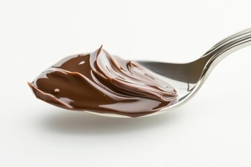 shiny silver spoon with a glossy bite of pudding chocolate swirl melting poised on a clean white background rich and smooth